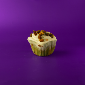 A pistachio cupcake filled with pistachio pudding, topped with pistachio cream cheese icing and finished with crushed pistachios. Pistachio cupcake