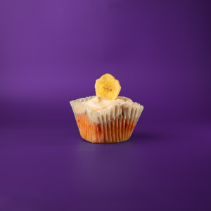 A strawberry cupcake, filled with banana pudding, topped with strawberry cream cheese icing and finished with a banana chip. Straw-Nana cupcake