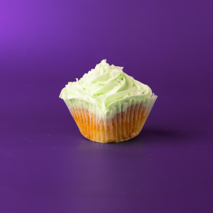 A coconut cupcake with a coconut/lime pudding filling, topped with lime buttercream then sprinkled with coconut flakes. Lime in the Coconut cupcake