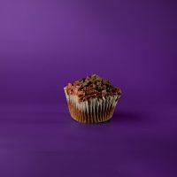 A chocolate cupcake filled with chocolate ganache, topped with chocolate buttercream, chocolate drizzle, and chocolate chips. Chocolate Decadence cupcake