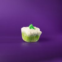 A key lime cupcake with key lime pudding filling, topped with vanilla buttercream and finished with a lime candy piece. Key Lime cupcake