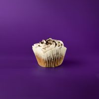 An Oreo cupcake with vanilla buttercream topped with Oreo crumbles. Oreo cupcake