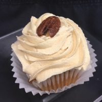 A maple pecan cupcake, topped with brown sugar cream cheese icing and finished with a full pecan. Butter Pecan cupcake