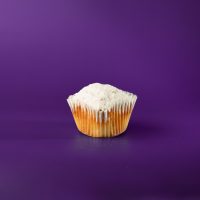 A poundcake cupcake topped with a dusting of powdered sugar. Poundcake