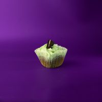 A mint Oreo cupcake frosted with mint cream cheese icing then topped with 1/4 of an Oreo cookie. Grasshopper cupcake