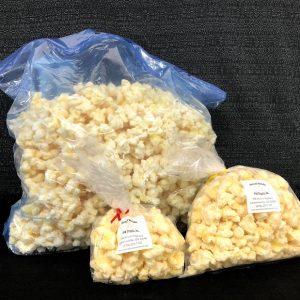 Premium white chocolatey coated puff-corn that is gluten free, kernel-less, and hull-less. A specialty of our Special needs adults. Available in 5 oz., 15 oz., and extra-large 150-oz. bags. Choc-Corn