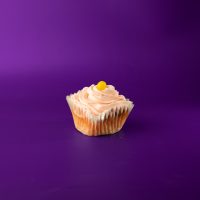 A pink lemonade cupcake filled with pink lemonade pie filling, topped with pink lemonade cream cheese icing and finished with a lemon head candy piece. Pink Lemonade cupcake