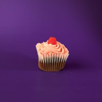 A dark chocolate raspberry cupcake iced with raspberry cream cheese icing and topped off with a raspberry candy piece. Dark Chocolate Raspberry cupcake