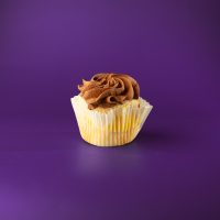 Two yellow cupcakes with vanilla pudding filling and finished with chocolate buttercream. Boston Cream cupcake
