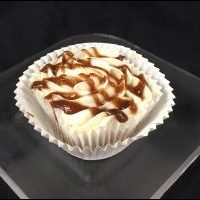 An apple butter cupcake with an apple butter filling, topped with cream cheese icing and finished with an apple butter apple cider drizzle. Apple Butter cupcake