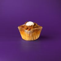 A butter pecan cupcake with pecan pie filling baked in and on top, finished with a small dollop of vanilla buttercream. Pecan Pie cupcake