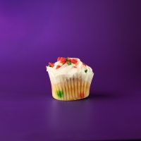 A peppermint crunch cupcake, topped with vanilla buttercream and finished with red and green peppermint crunch sprinkles. Peppermint Crunch cupcake