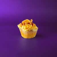 In remembrance of Elvis' birthday, a banana cupcake filled with a peanut butter and bacon mixture, topped with banana buttercream, drizzled with peanut butter ganache and finished with bacon pieces and a dried banana chip. Elvis cupcake