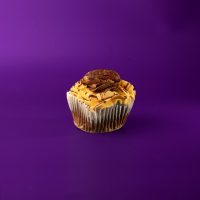 A chocolate cupcake filled with caramel, iced with chocolate and caramel buttercream, topped with caramel drizzle and a pecan. Turtle Cupcake