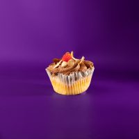 An almond cupcake with raspberry chocolate ganache filling, chocolate buttercream and finished with a candy raspberry and slivered almonds. Chocolate Raspberry Almond cupcake
