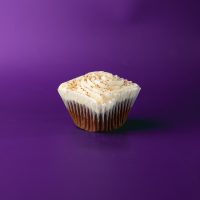 A chocolate cupcake topped with cream cheese icing and a sprinkle of cocoa powder. Chocolate Cream Cheese cupcake