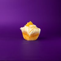A caramel cupcake with an apple pie filling, cream cheese icing, and topped with a drizzle of caramel and apple. Caramel Apple Pie cupcake