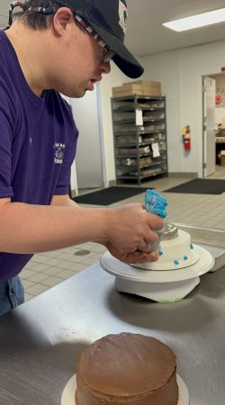 Philip A staff member decorating a cake