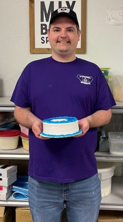 Jake M A staff member holding his decorated cake