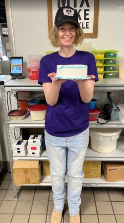 Riley A staff member holding her decorated cake